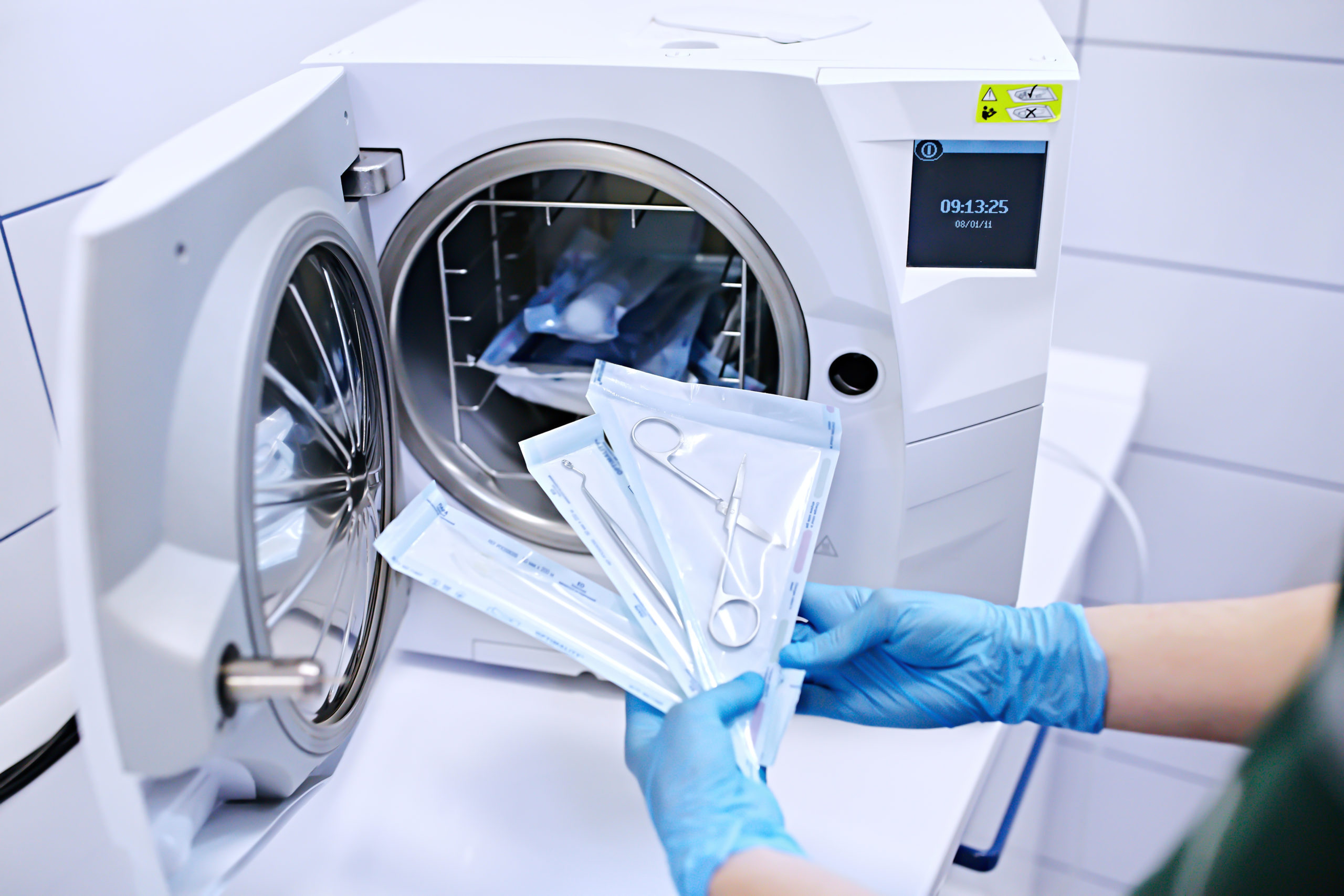 Hands,In,Blue,Gloves,Holding,A,Medical,Instrument.,Sterilizing,Box.